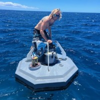 Greg, Surf Maui Now instructor, on ocean research equipment in Maui waters